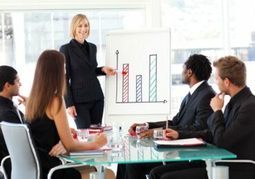 Businesswoman reporting to sales in a seminar