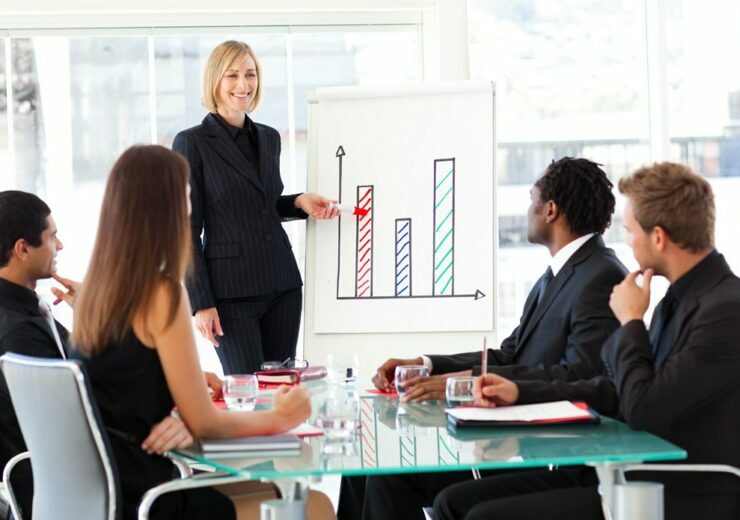 Businesswoman reporting to sales in a seminar